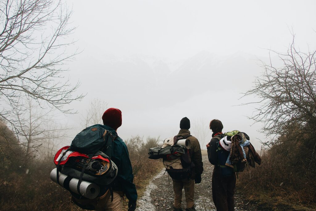 pexels photo 3604897 3604897 Three hikers explore a foggy winter trail, showcasing adventure and nature's beauty.